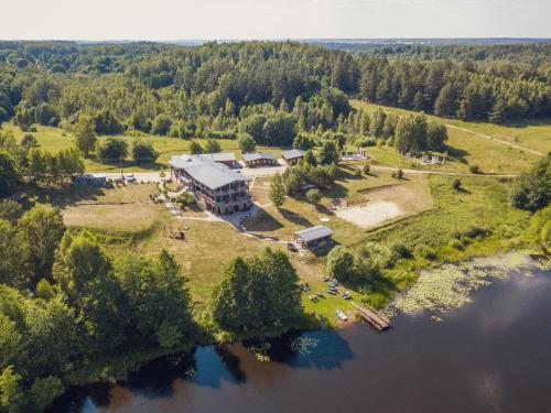 an aerial view of a house on an island in the water at Luokesų Dvaras in Molėtai