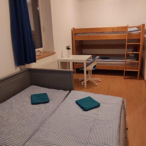 a bedroom with a bed and a table and a desk at Prázdninový dům Bezkov u Znojma in Bezkov