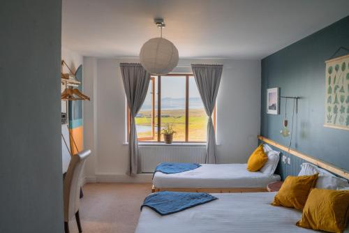 a room with two beds and a window at BigStyle Atlantic Lodge 