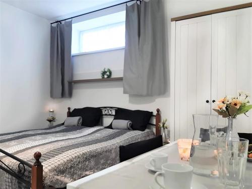 a bedroom with a bed and a table and a window at Rezidence 1923 in Kuchařovice