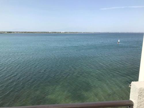 a large body of water with a boat in it at Ile du Cap Couladère - Vue magnifique lac marin - Baignoire Jaccuzi - Complexe piscine, sportif, animations in Le Barcarès