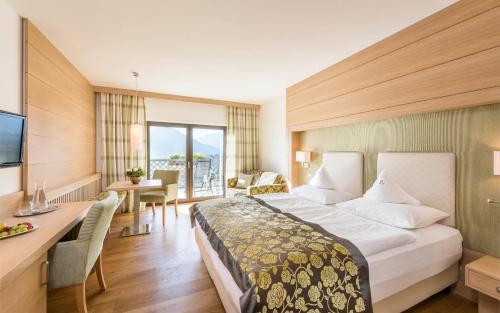 Postel nebo postele na pokoji v ubytování Hotel Lagrein