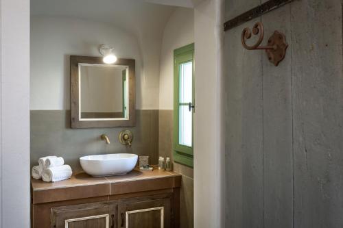 a bathroom with a sink and a mirror at Gallicantu Stazzo Retreat in Luogosanto
