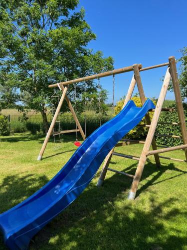 a playground with a blue slide in a park at Wohlfühlvilla Garding in Garding