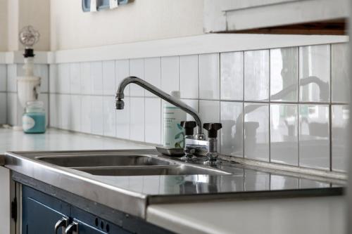 a kitchen sink with a faucet on top of it at Holiday apartment in Vimmerby with cozy courtyard in Vimmerby