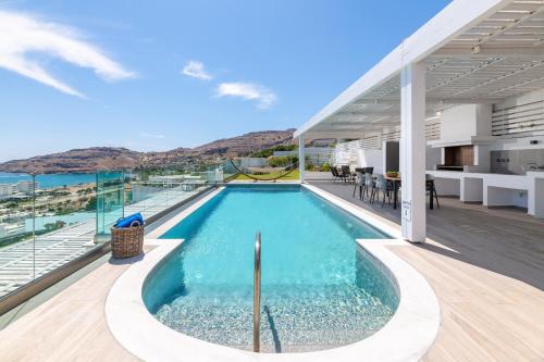 a swimming pool with a view of the ocean on a house at Villa Kastro in vlicha