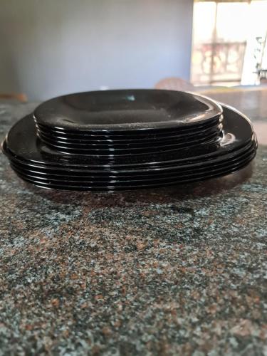 a black toilet seat sitting on top of a counter at Unia fancy flats 3 bed room apartment- Flat 2 in Kampala
