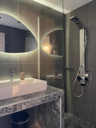 a bathroom with a sink and a shower at Litsa Apartments in Fourka