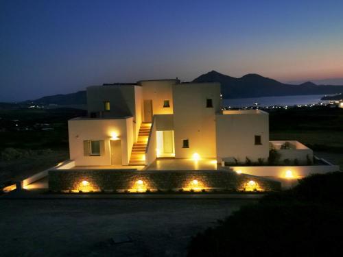 a large white building with lights in front of it at Κallisto rooms in Mytakas
