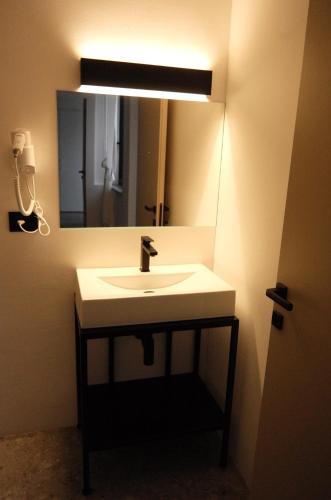 a bathroom with a sink and a mirror at Terrazza Central Apartments in Bolzano