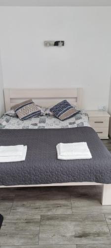 a bed with two pillows on it in a bedroom at Unibal domki 2 osobowe in Mielno