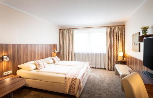 Katil atau katil-katil dalam bilik di QU Hotel Augsburg