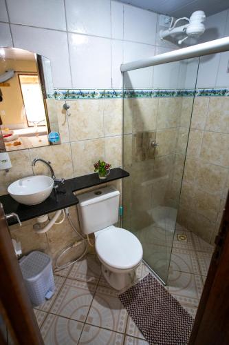 a bathroom with a toilet and a sink and a shower at Pousada Aventurine Noronha in Fernando de Noronha