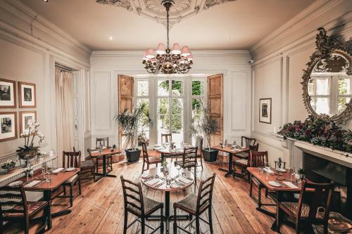 a dining room with tables and chairs and a chandelier at York Pavilion Hotel, Sure Hotel Collection by Best Western in York