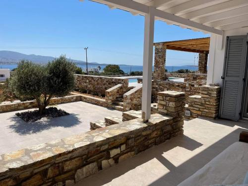 a stone wall in front of a house at Sorokos Villa Panagia beach in Andiparos
