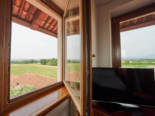 a room with a window with a view of a field at Relais Santo Stefano in Sandigliano