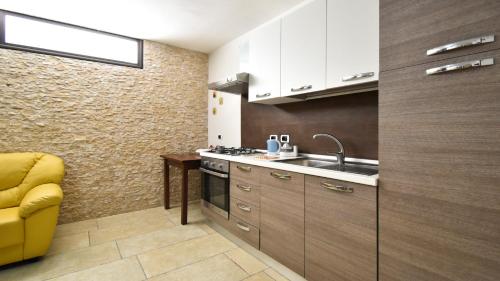 a small kitchen with a sink and a stove at Casa Carlà by Rentbeat in Surbo