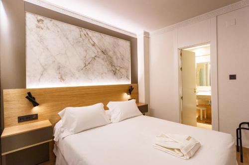 Ένα ή περισσότερα κρεβάτια σε δωμάτιο στο Hotel Dauro Premier