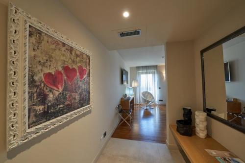 a living room with a large painting on the wall at Relais Santo Stefano in Sandigliano