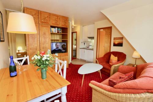 a living room with a couch and a table at Inselresidenz Strandburg - Ferienwohnung 303 (Ref. 50971) in Juist