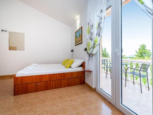 a bedroom with a bed and a sliding glass door at Apartments Prkačin in Starigrad-Paklenica