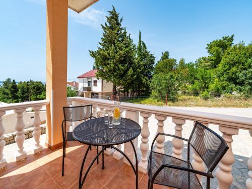 a balcony with a table and chairs on a porch at Apartments Prkačin in Starigrad-Paklenica