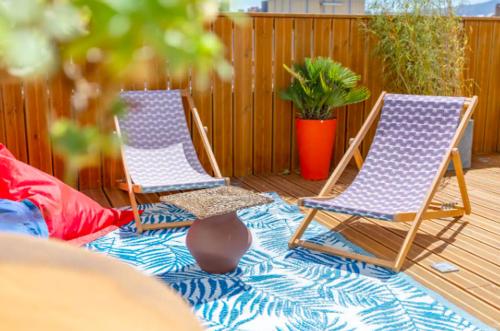 two chairs sitting on a patio with a rug at STUDIO ** ROOFTOP ** LULLI in Marseille