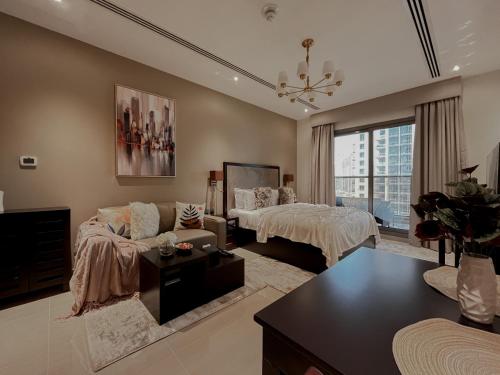 a large living room with a bed and a couch at Trophy - Sky High Haven Suite in Dubai