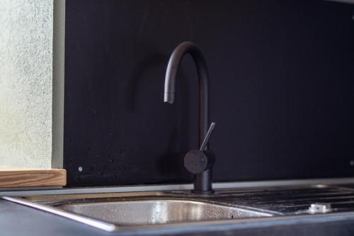a kitchen sink with a faucet on top of it at Holiday Home Lož in Stari Trg pri Ložu