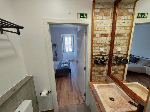 a bathroom with a sink and a mirror at Wolley - Peniche GuestHouse in Peniche