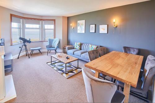 a living room with a table and a couch at Host & Stay - The Puffins Nest in Seahouses