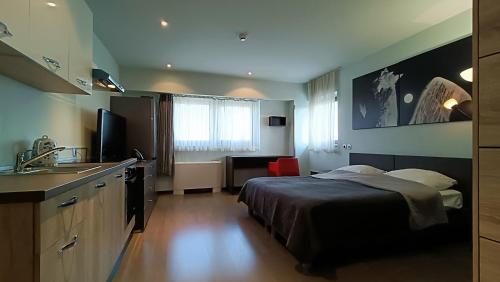 a hotel room with a bed and a sink at Nitro Rooms in Ljubljana