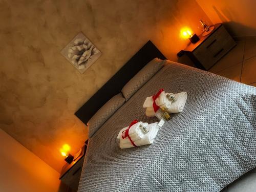 a bedroom with a bed with two santa claus bottles on it at B&B L'agrumeto in Nocera Inferiore