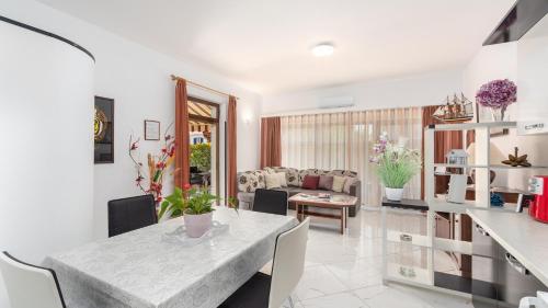 a living room with a table and a couch at Apartments in City Centar of Lovely Vrsar in Vrsar
