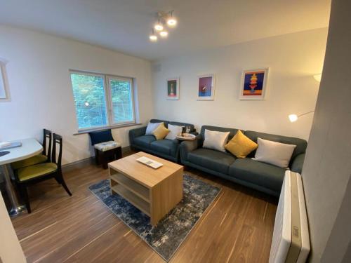 a living room with a couch and a table at Location Location - Gorgeous 3 Bed Apartment in Killarney in Killarney