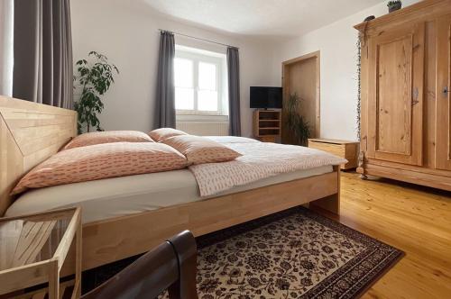 a bedroom with a large bed with a wooden headboard at Lieselhaus in Busenberg