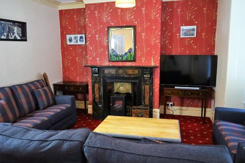a living room with a couch and a tv and a fireplace at Nineteen in Bridlington