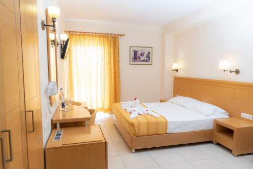 a hotel room with a bed and a table with towels at Astir Beach Hotel in Gouves