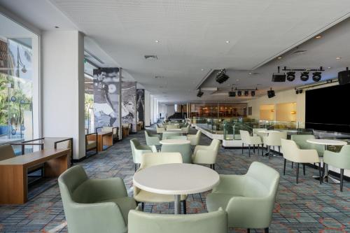 a restaurant with tables and chairs and a bar at Sport Club by Isrotel Collection in Eilat