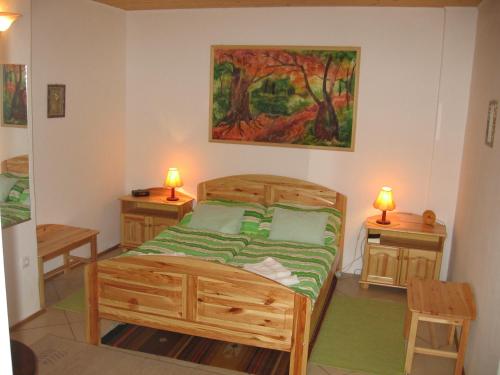een slaapkamer met een bed en twee nachtkastjes bij Családi Vendégház in Eger
