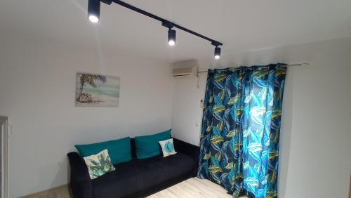 a living room with a couch and a curtain at Apartments Radovic in Petrovac na Moru