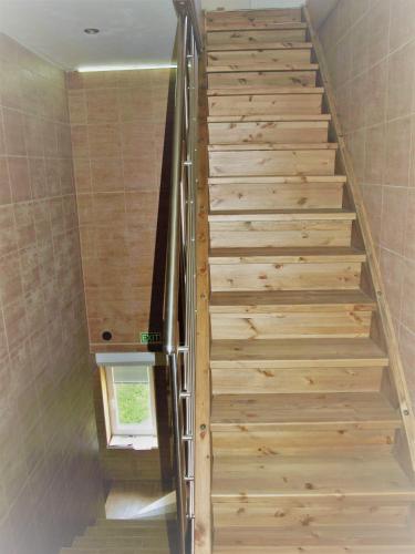 a staircase in a house with wooden steps at Resort LUFT Sněžník in Sněžnik