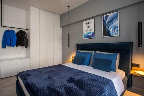 a bedroom with a large bed with blue pillows at Rhodes Diamond luxury flat in the heart of town in Rhodes Town