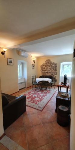 a living room with a couch and a fireplace at Villa Sunrise in Herceg-Novi
