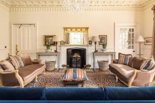 a living room with a blue couch and a fireplace at Healey Hall in Healey