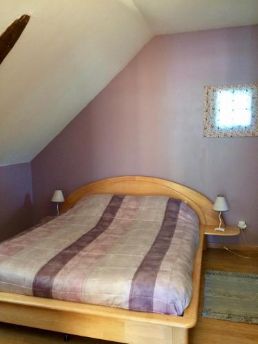 a bedroom with a bed in a attic at Domaine de Galoubet, Lot , Gîtes de charme in Beaumat