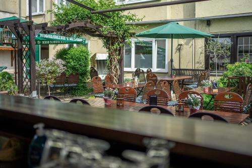 an outdoor patio with tables and chairs and an umbrella at Zwehrener Hof in Kassel