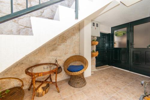 a room with a table and chairs and stairs at Apartments Stinice in Gradac