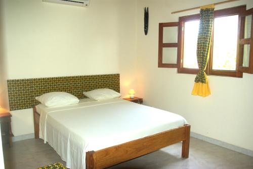 En eller flere senge i et værelse på Bolongs Passion