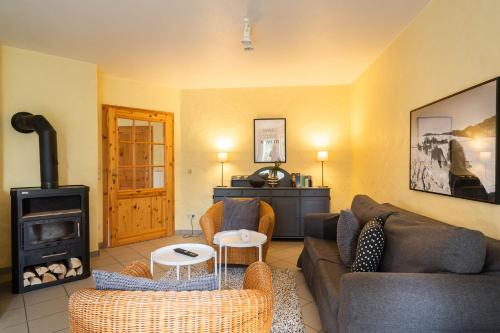 a living room with a couch and a wood stove at Ferienhof Homann Sauerland in Brilon